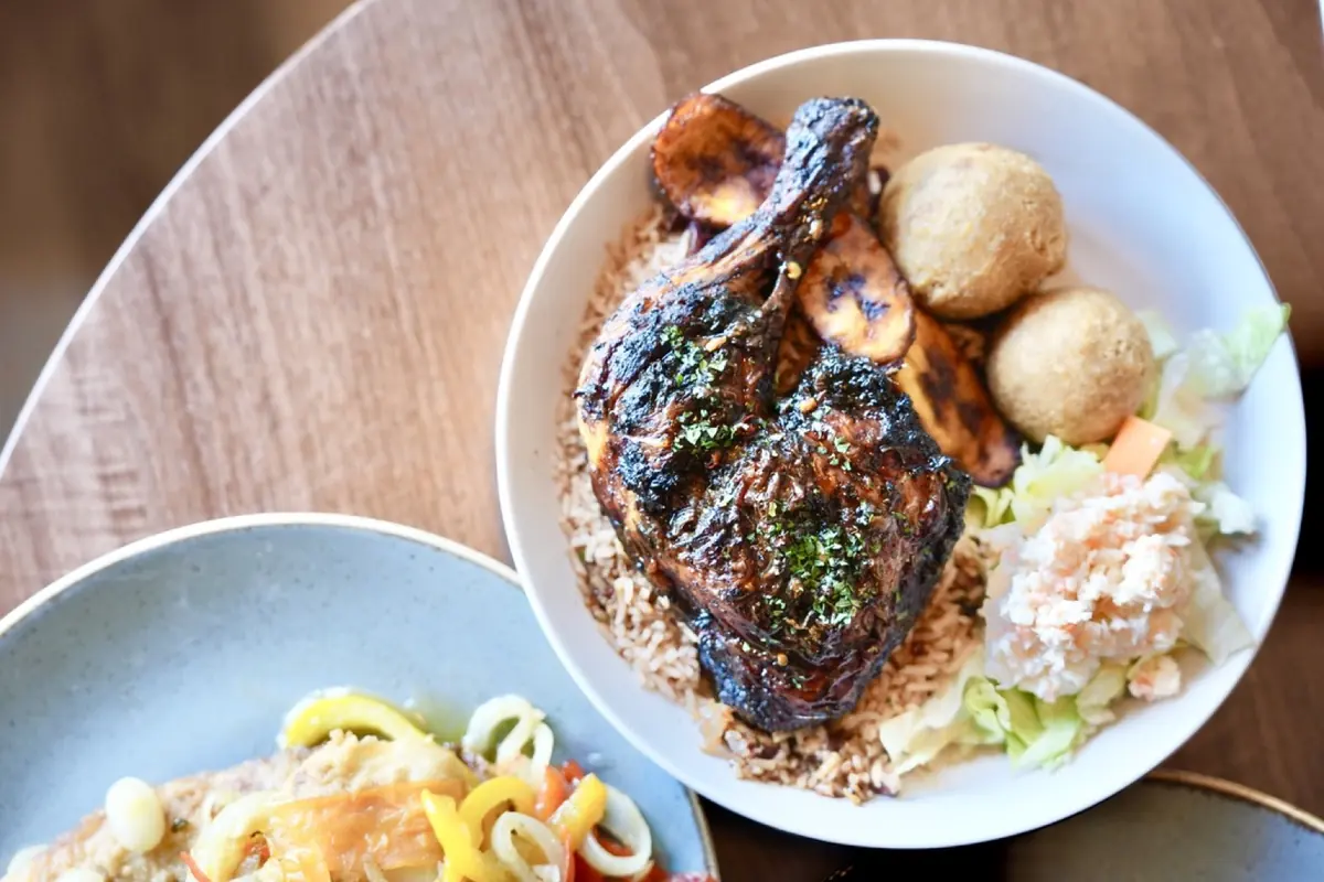 Curry goat with rice, olives and a fried dumpling, close from above